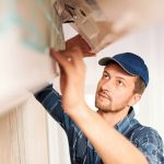 worker checking AC problems